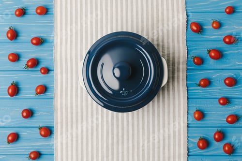 Preview: top view of cherry tomatoes with pan on blue table