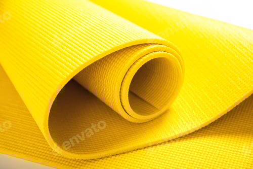 Preview: Bright Yellow Rolled Yoga Mat on White Surface