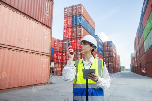 Preview: Engineer port manager communicating in container yard