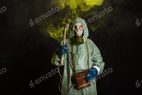 Preview: Radiation and danger concept - Man in the gas mask and chemical suit. The worker doing measure