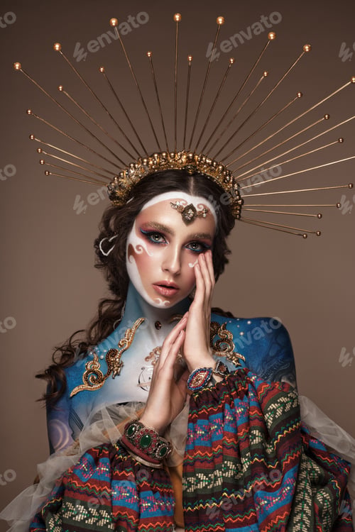Preview: Portrait of a girl with gold and blue creative art make-up.