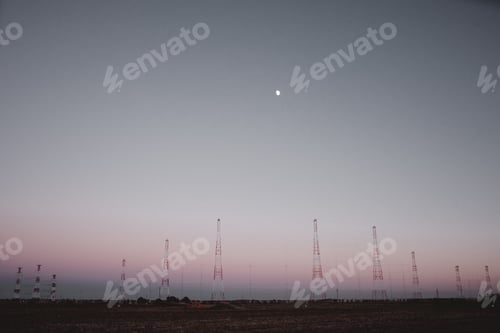 Preview: Tall electric posts in field