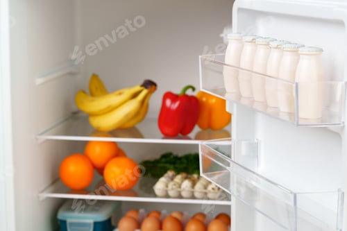 Preview: White Refrigerator Open With Fresh Produce and Dairy