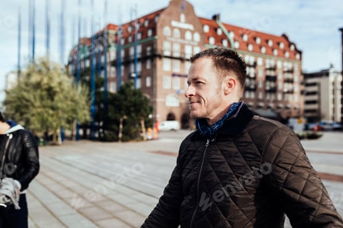 Preview: Smiling mature man in town square