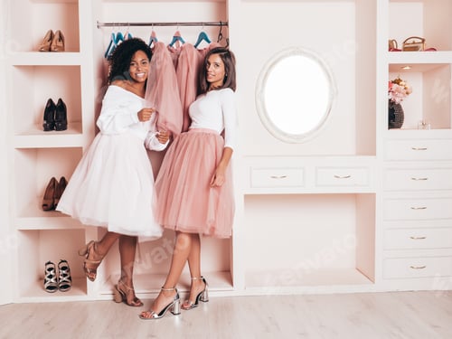 Preview: Portrait of two young beautiful women posing in pink wardrobe