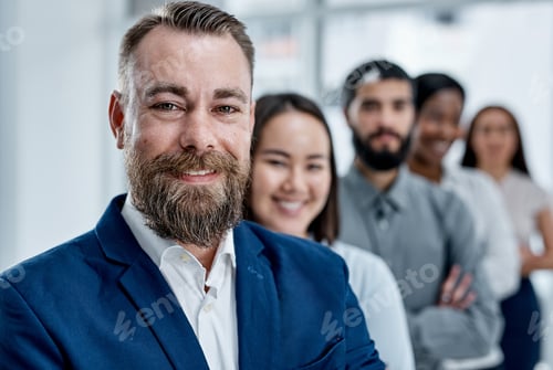 Preview: Portrait of a businessman standing in an office with his colleagues in the background