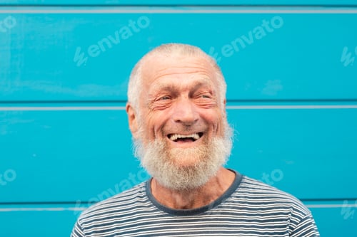 Preview: 75 year old senior man laughs while having a good time outdoors. Portrait