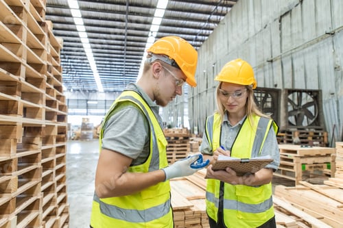 Preview: engineer carpenter wearing safety uniform and hard hat working holding clipboard checking qualit