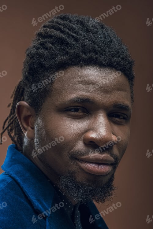 Preview: portrait of handsome african american man with dreadlocks isolated on brown
