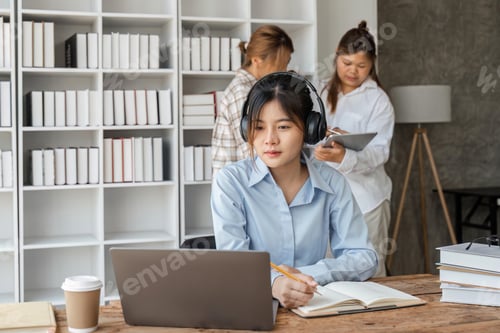 Preview: Smiling girl with headset studying online, using laptop