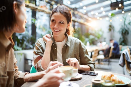 Preview: Positive women discussing last news in cafe
