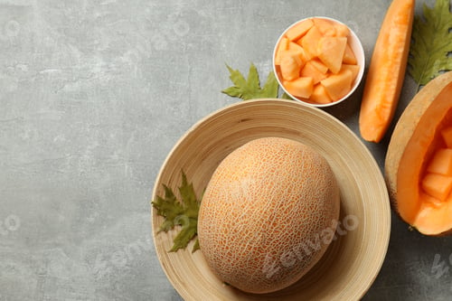 Preview: Concept of fresh food with melon on gray textured table