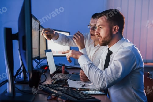Preview: Stressful work. Two stock traders is in the office with exchange technology on monitors