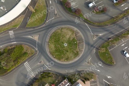 Preview: Aerial view of road roundabout intersection with fast moving heavy traffic.