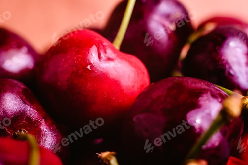 Preview: Close-up of Ripe Cherries on Orange Background