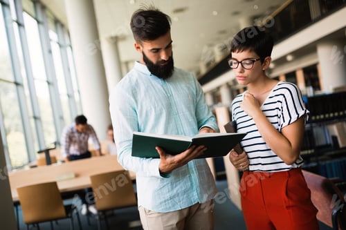 Preview: Young attractive students spending time in library