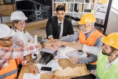 Preview: Happy multiracial architects, engineers and designers stacking their hands together