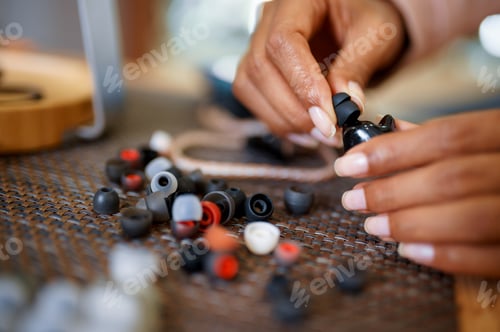Preview: Woman choosing ear pads in audio store, music fan