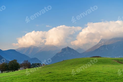 Preview: Beautiful landscape of the misty hazy Italian Alps mountain range during evening. Lombardy, Italy