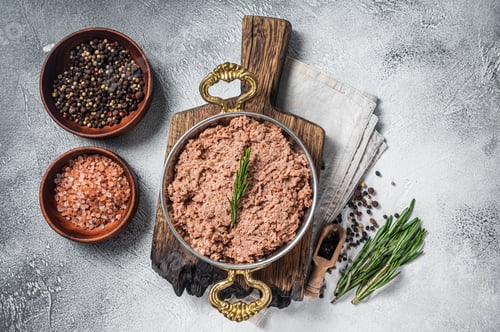 Preview: Uncooked vegan mince meat, raw plant based meat with thyme in skillet.
