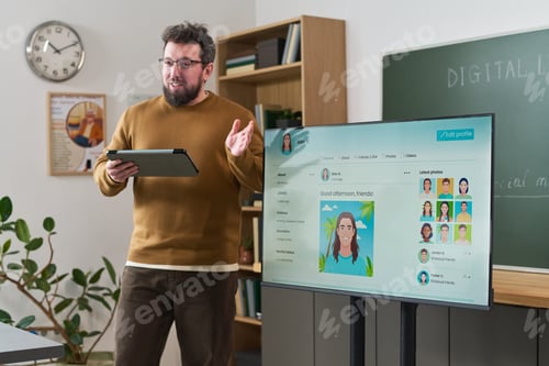 Preview: Caucasian Young Adult Man Teaching Computer Literacy Course Using Tablet Device