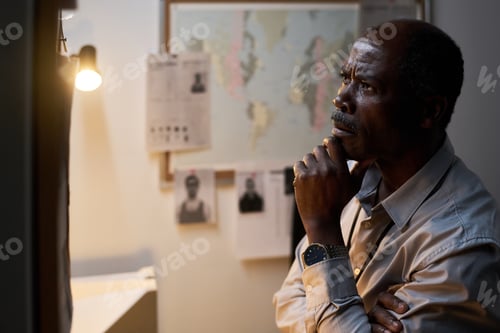 Preview: Contemplating Elderly Man Standing in Office