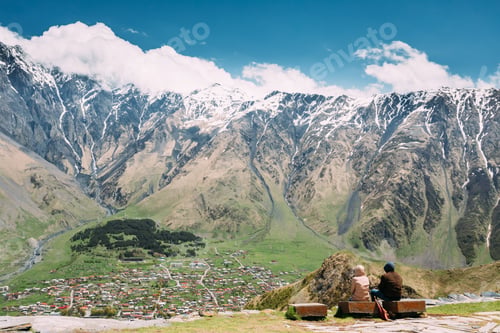 Preview: People Sitting Together On A Stone Bench Near The Gergeti Trinit