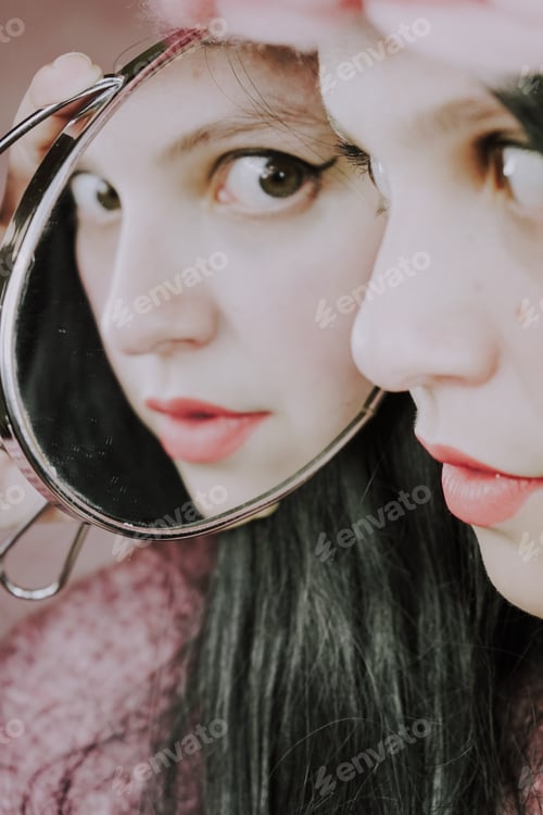 Preview: Close up of a beautiful woman reflected in a mirror