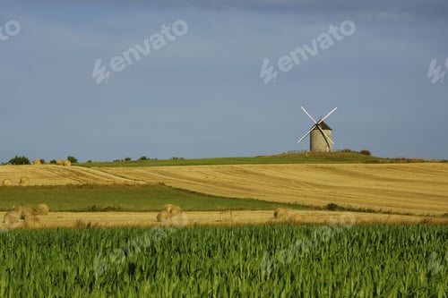 Preview: Beautiful view of a windmill on a farm field in Normandy, France