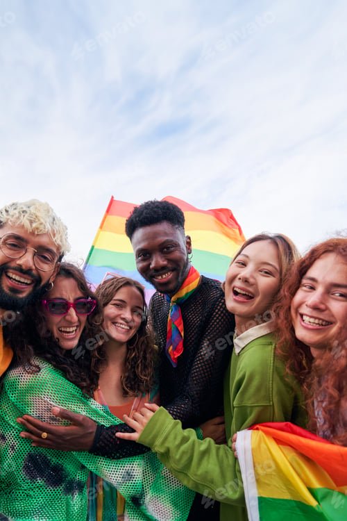 Preview: Group of multiracial LGBTQI people hugging, celebrating Pride month together in support of inclusion