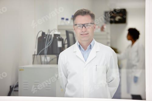 Preview: Scientist smiling in laboratory, colleague working in background
