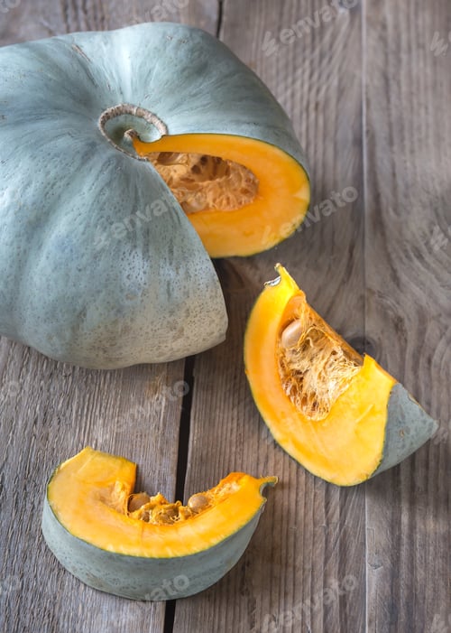 Blue Hubbard Squash Slices on Rustic Wood Surface