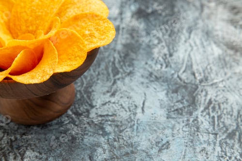 Preview: Half shot of potato chips decorated like flower shaped in a brown bowl on gray background footage