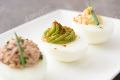 Preview: Chef placing delicious toppings on deviled eggs for elegant appetizer