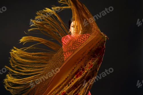 Preview: Flamenco dancer performing with a dramatic fringed shawl, capturing passion and movement