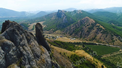 Preview: Top view of a mountainous area with a settlement on a summer day. Shot. Private houses in a village