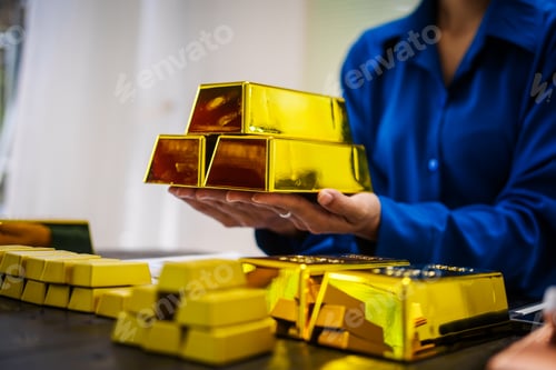 Preview: An Asian business woman sitting at her desk in office,analyzing gold bullion prices,market trends