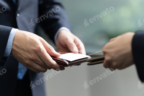 Preview: A close-up of a Japanese businessman exchanging business cards