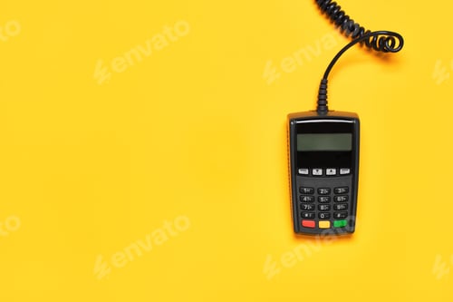 Preview: POS payment terminal on yellow background. Minimal financial service flat lay, copy space.