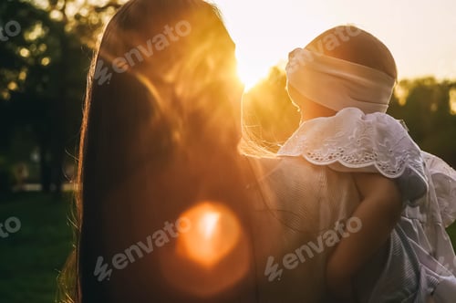 Preview: Mother and little daughter rear view. Sunset light.