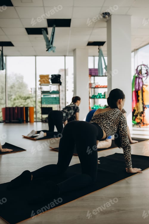 Preview: Group of young sporty people practicing yoga lesson with instructor, stretching in Child exercise