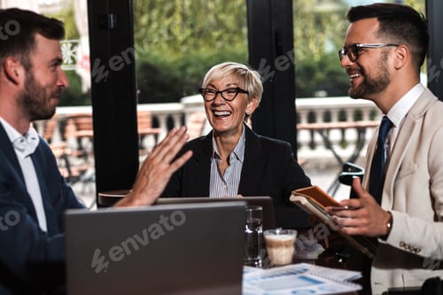 Preview: Group of business people having a meeting at office cafeteria.