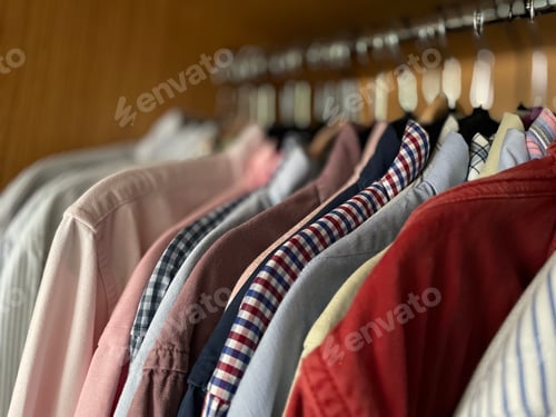 Preview: Neatly Arranged Shirts Hanging in Closet
