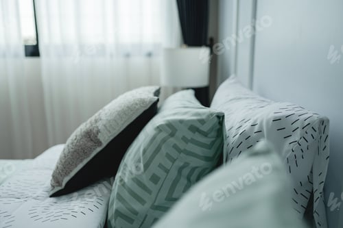 Preview: modern pillows and calming bedding set arrangement and color palette make the setting ideal relaxing