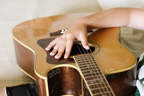 Preview: Girl playing acoustic guitar at home