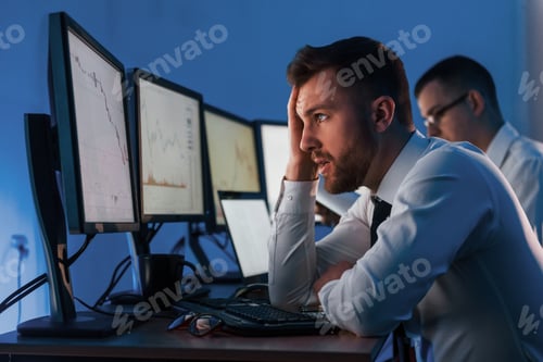 Preview: Concept of failure. Two stock traders working in the office with exchange technology