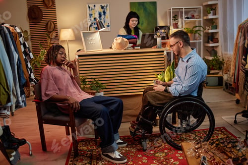 Preview: Caucasian Man with Disability in Casual Talk with Young Black Man in Thrift Shop