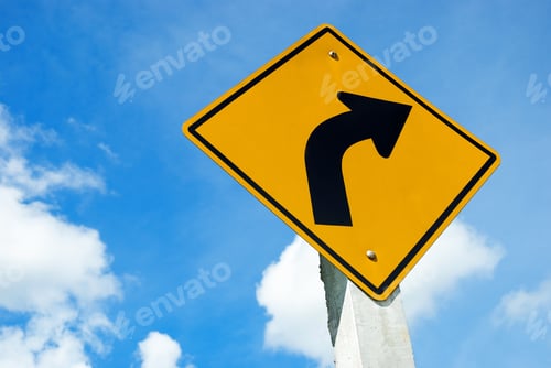 Preview: Road sign warning of dangerous left curve on blue sky