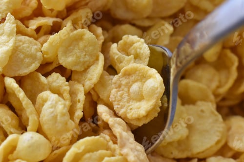 Preview: Cornflakes on spoon. Cereal background.