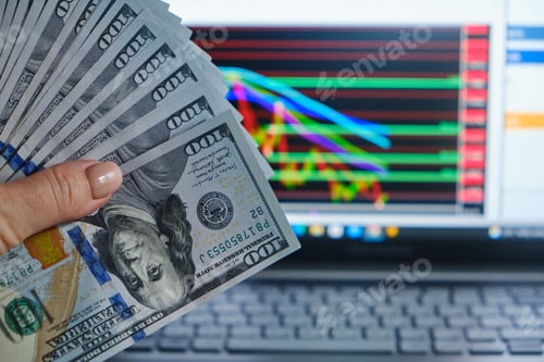 Preview: dollars bills and woman hand against the background of screen
